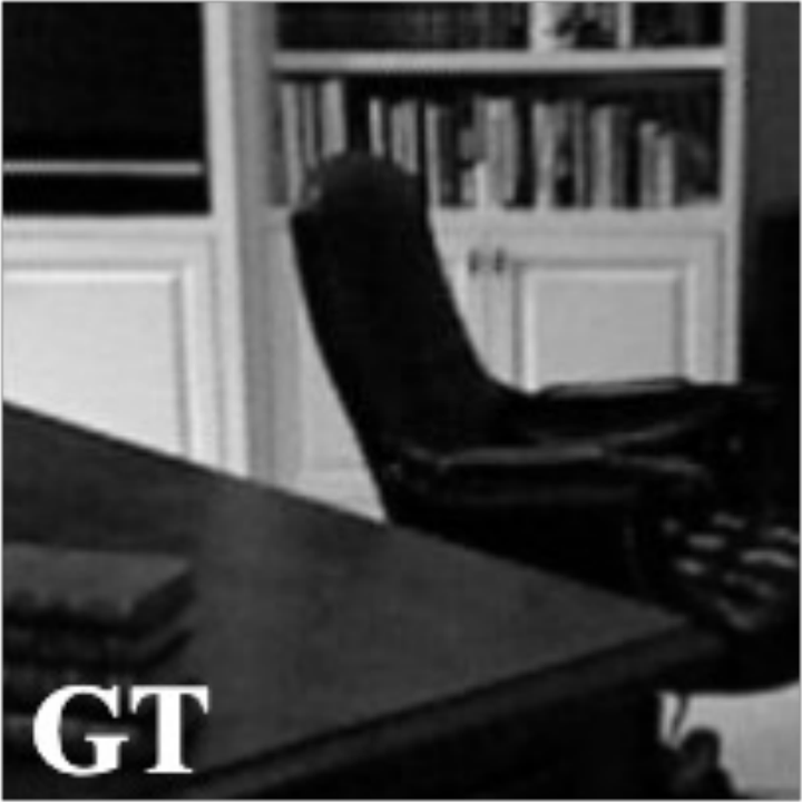 Ground-truth reflectivity: a study interior, with a bookcase, a dark armchair and a stack of books on a table edge.